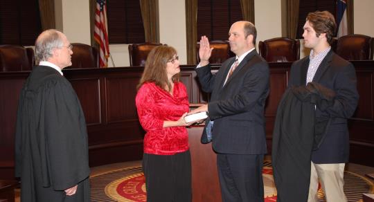 Chief Justice Bill Waller Jr. administers the oath to Justice Robert P. Chamberlin